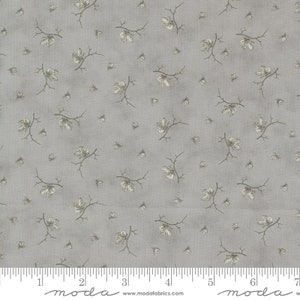 May include: A gray fabric with a repeating pattern of small, light green branches with leaves. The fabric has a subtle texture and a slightly faded look.