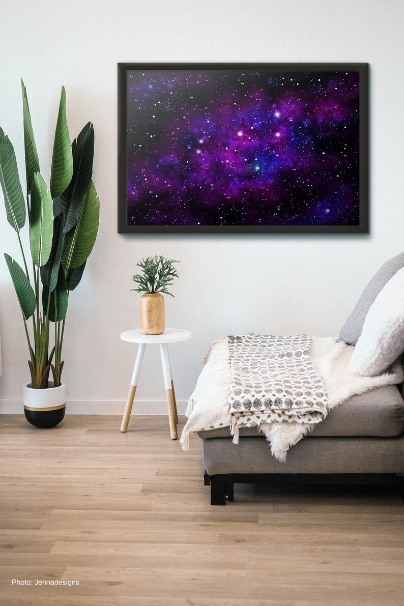 May include: A framed print of a galaxy with a purple and blue nebula and white stars against a black background.