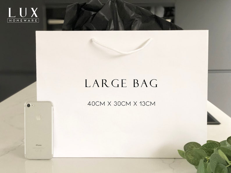 May include: White paper shopping bag with black text that reads "LUX HOMEWARE" and "LARGE BAG 40CM X 30CM X 13CM".