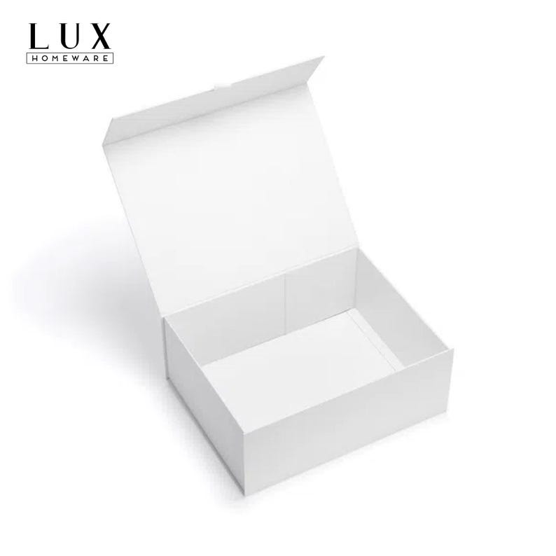May include: A white, rectangular gift box with a magnetic closure, shown open. The box is empty and has a clean design. The top left corner features the text "LUX HOMEWARE".