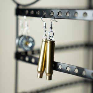 May include: A rustic wooden sign with the text "Welcome to our home" in white lettering. The sign features a distressed finish and a simple, inviting design, perfect for a front porch or entryway.