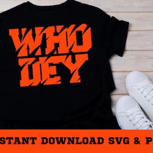 Peut inclure: T-shirt noir avec les mots "WHO DEY" en orange, imprim&eacute;s dans une police de caract&egrave;res dentel&eacute;e.