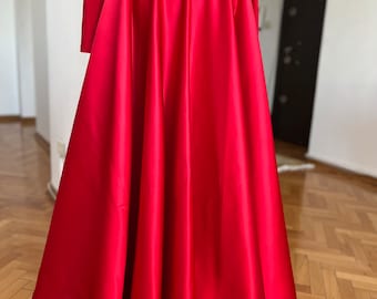 May include: A long, red satin skirt with a fitted waist and a full, flowing skirt.