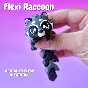 May include: A 3D-printed, articulated Flexi Raccoon figurine in shades of gray, black, and white, held against a purple background. The text "Flexi Raccoon" and "DIGITAL FILES FOR 3D PRINTING" are visible. The raccoon has large eyes and a segmented tail.