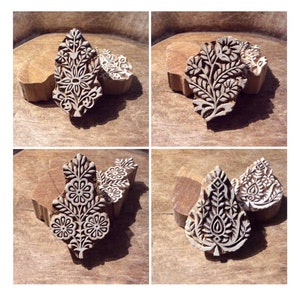 May include: Four wooden printing blocks featuring intricate floral designs. The blocks are carved with detailed patterns of leaves, flowers, and swirls. They are ideal for creating unique patterns on fabric or paper.