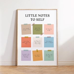 May include: A framed print with the text "LITTLE NOTES TO SELF" at the top. Below are nine colourful sticky notes with handwritten motivational phrases. The print is displayed on a wooden floor.