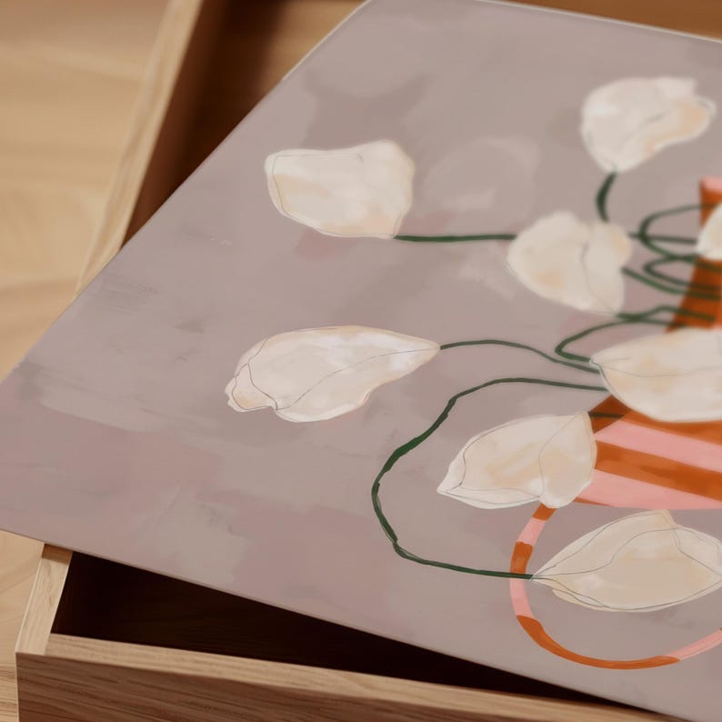 May include: A decorative tray with a floral design. The tray features a muted mauve background with a watercolor illustration of white flowers and green stems. A vase with orange and pink stripes is also visible.