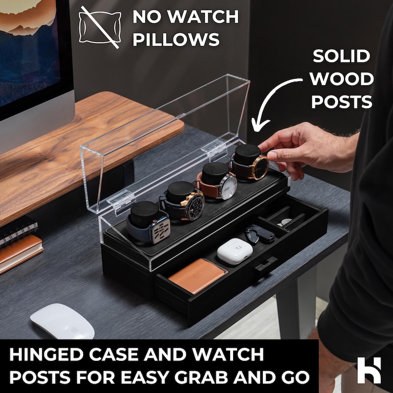 May include: A black watch display case with a clear hinged lid, featuring solid wood posts. The case holds several watches and has a drawer with small compartments. Text on the image reads "NO WATCH PILLOWS" and "HINGED CASE AND WATCH POSTS FOR EASY GRAB AND GO."