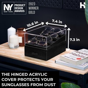 May include: A black tiered eyewear organizer with a clear hinged acrylic cover, holding four pairs of sunglasses. The unit measures 10.6 inches in length, 7.4 inches in width, and 7.3 inches in height. The text on the image reads: The hinged acrylic cover protects your sunglasses from dust.