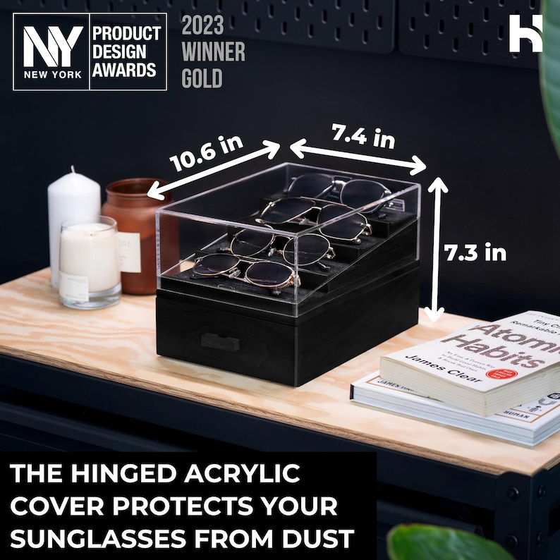 May include: A black tiered eyewear organizer with a clear hinged acrylic cover, holding four pairs of sunglasses. The unit measures 10.6 inches in length, 7.4 inches in width, and 7.3 inches in height. The text on the image reads: The hinged acrylic cover protects your sunglasses from dust.