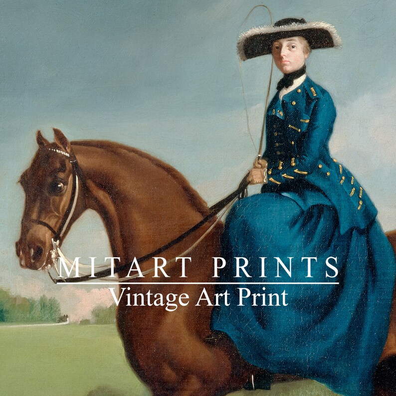 May include: A vintage art print of a woman in a blue dress and a black hat riding a brown horse. The print is titled "MITART PRINTS Vintage Art Print".