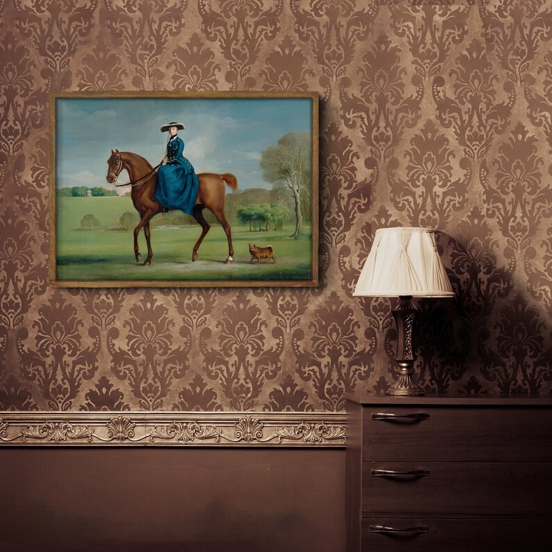 May include: A framed painting of a woman riding a brown horse in a field. The woman is wearing a blue dress and a hat. A small dog is walking behind the horse.
