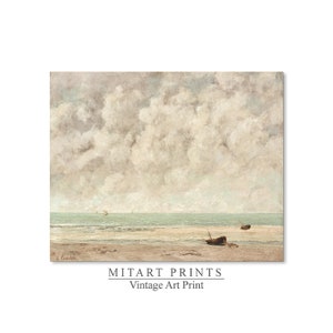 May include: A vintage art print of a seascape with a cloudy sky and a beach with two small boats. The print is in muted tones of blue, gray, and white.