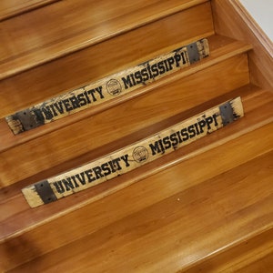 May include: Two wooden stair treads with the words "University of Mississippi" and the university logo engraved on them.