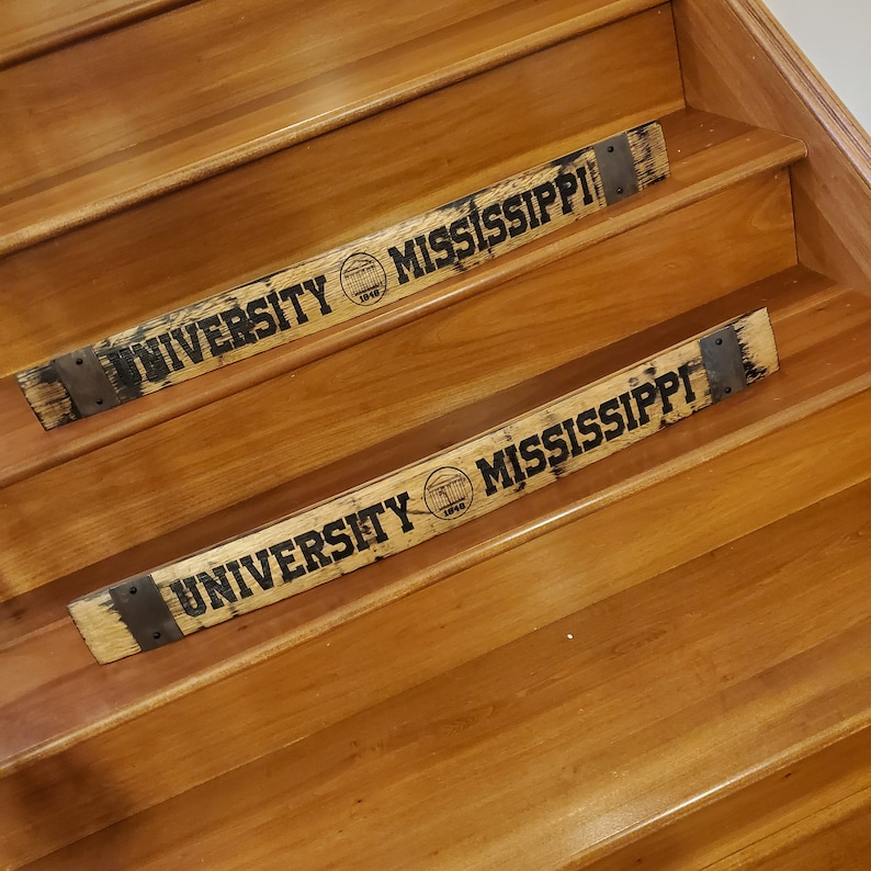 May include: Two wooden stair treads with the words "University of Mississippi" and the university logo engraved on them.