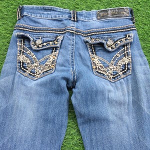 Low rise bootcut light blue wash 2000’s grunge style low waist embellished embroidered signature rise flared jeans
