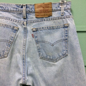 Size 33 Vintage Distressed Levis 550 Jeans W33 L33 Light Wash Dirty Denim Relaxed Fit Tapered Leg Jeans Made In USA Waist 33"