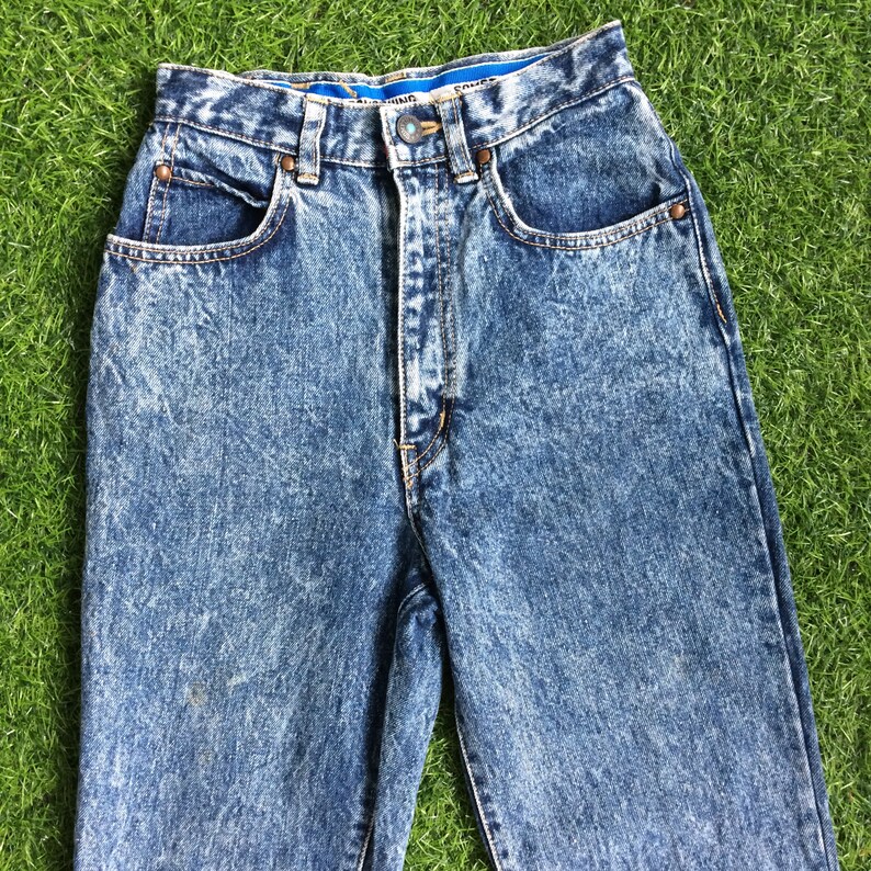 May include: A pair of light blue acid wash denim jeans with a high waist and a straight leg.