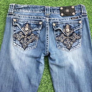 Miss Me medium light blue wash 2000’s grunge style low-rise embellished embroidered signature rise boot jeans