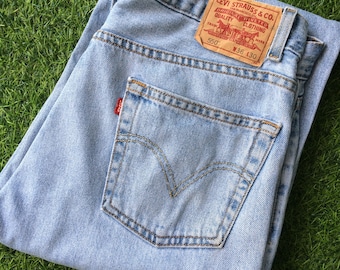Calça jeans vintage Levi's 550, tamanho 34 (cintura) x 28 (comprimento), lavagem clara com efeito desgastado.