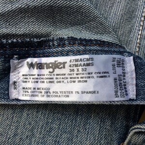 May include: A white Wrangler jeans care label with blue text. The label states "47MACMS 47MAAMS 36 X 32" and includes washing instructions. The label also states "Made in Mexico 78% Cotton 29% Polyester 1% Spandex Exclusive of Decoration."