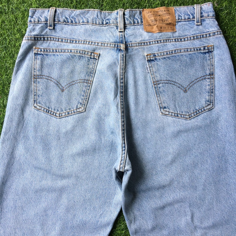 May include: Light blue denim jeans with a brown leather patch on the back pocket that says "Levi Strauss & Co.".