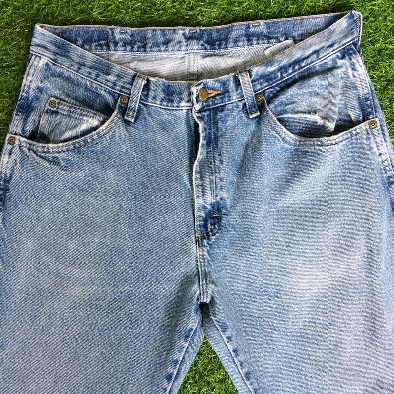 May include: A pair of light blue denim jeans with a classic five-pocket style. The jeans have a faded look and are made of a soft, comfortable cotton blend.