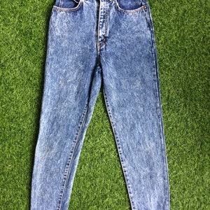 May include: Light blue acid wash denim jeans with a high waist and a straight leg.