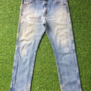 May include: A pair of light blue denim jeans with a faded look. The jeans have a straight leg and a classic five-pocket design.