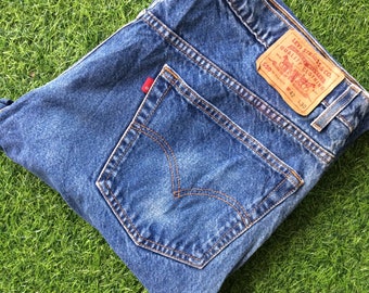 May include: A pair of blue denim jeans with a back pocket and a Levi Strauss & Co. label that reads "550" and "W42 L30".