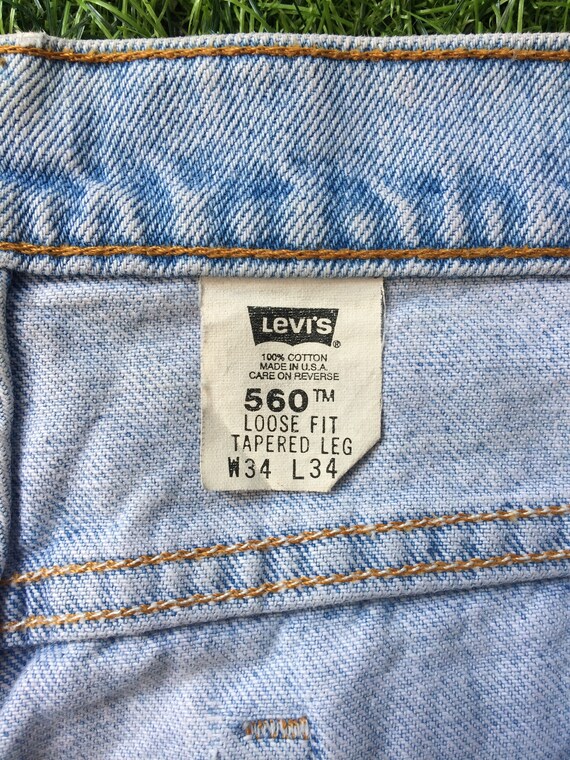 90s Levi's 560 Loose Fit Tapered Leg Ripped USA Made Light Wash Jeans  VINTAGE