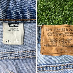 May include: A pair of blue denim jeans with a brown leather Levi's label. The label says "Levi Strauss & Co. San Francisco Cal. Original Rivited Quality Clothing" and has the size "W 38 L 32".