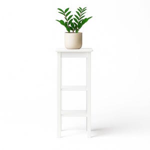 May include: A white plant stand with three shelves supports a potted plant. The plant has vibrant green leaves and is in a beige pot. The stand is made of wood and has a simple, clean design, perfect for displaying plants.