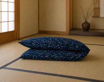 May include: Two rectangular pillows stacked on top of each other, featuring a dark navy blue fabric base with a repeating pattern of small, colorful dragonflies in shades of light blue, white, and yellow across the entire surface of the pillows.