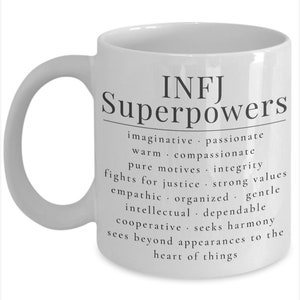 May include: White ceramic mug with a black design that reads "INFJ Superpowers" and lists personality traits associated with the INFJ personality type.