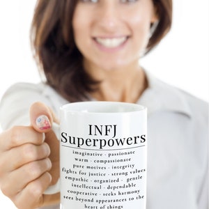 May include: White ceramic mug with a black design that reads "INFJ Superpowers" and lists personality traits associated with the INFJ personality type.