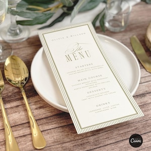 May include: A wedding menu card with gold text and a decorative border, placed on a white plate. The menu lists starters, main courses, desserts, and drinks. Gold silverware and a glass are visible.