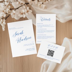May include: A set of elegant wedding stationery featuring white cards with navy blue calligraphy. The invitation card displays the names "Sarah and Hudson" and event details. Additional cards include "The Details" and an RSVP with a QR code.