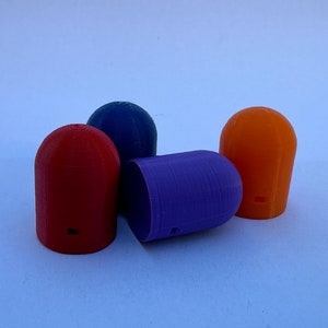 May include: Four colorful, dome-shaped, plastic bottle stoppers. The stoppers are red, blue, purple, and orange.