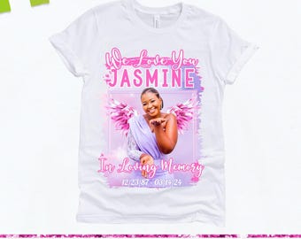 May include: White t-shirt featuring a memorial design. The design includes the text "We Love You Jasmine" in pink, a photo of a woman, and the dates 12/23/87 - 03/14/24. The words "In Loving Memory" are also included.