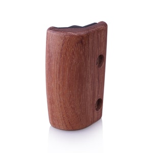 May include: A wooden knob with a dark brown finish and two holes. The knob is designed for use on furniture or cabinets.