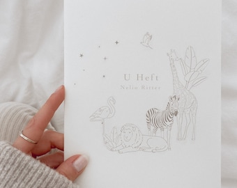 May include: A white card with a line drawing of a giraffe, zebra, lion, flamingo, and a bird flying. The text "U Heft" and "Neljo Ritter" is printed on the card.