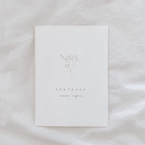 May include: A white card with the words "Impfpass marie sofie" in a minimalist font. A delicate, black line drawing of a small flowering plant is above the text. The card is set against a white, textured background.