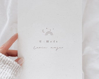 May include: A white card with a simple black and white illustration of a rainbow, moon, and stars. The text "U. Heft" and "Levin Majer" is written in cursive below the illustration.
