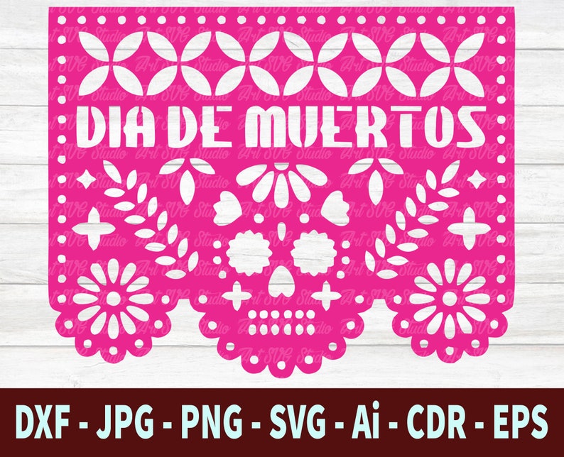 May include: A pink paper cutout with a white design of a skull and flowers. The text "DIA DE MUERTOS" is written in white across the top.