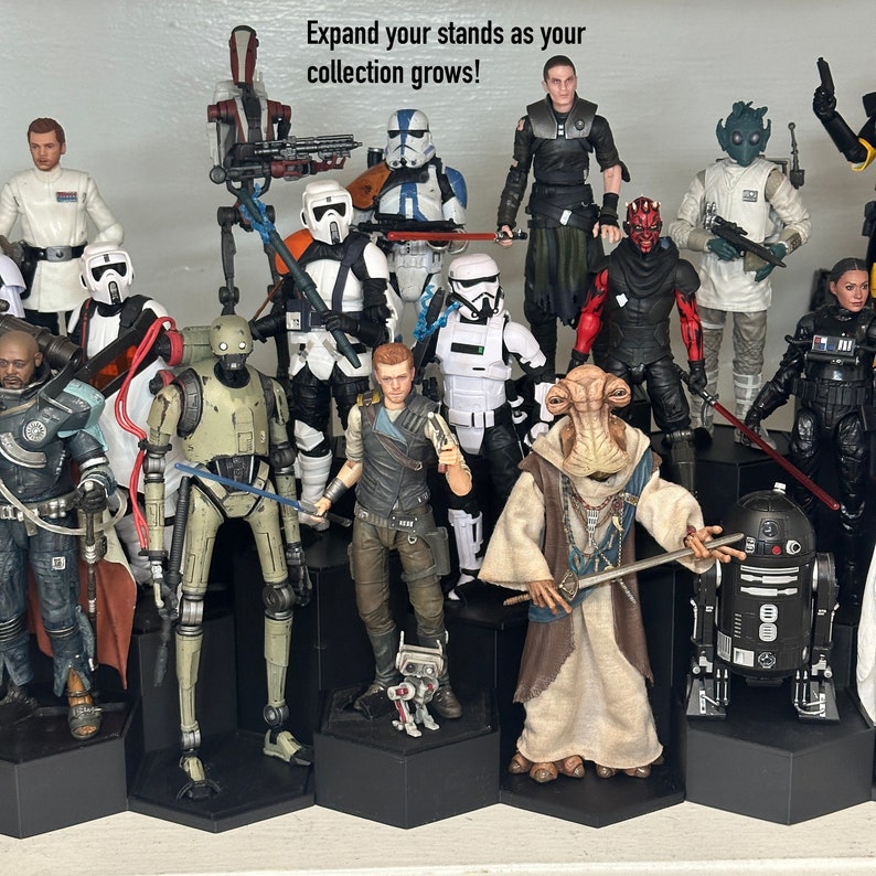May include: A collection of Star Wars action figures on display stands. The figures include characters such as Darth Vader, Yoda, and Boba Fett. The figures are all in different poses and are displayed on black hexagonal stands. The text "Expand your stands as your collection grows!" is written at the top of the image.