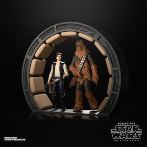 May include: A diorama featuring Han Solo and Chewbacca from Star Wars: The Black Series. The figures are standing in a circular doorway with a wood-like texture. The diorama is scaled for the Black Series figures.