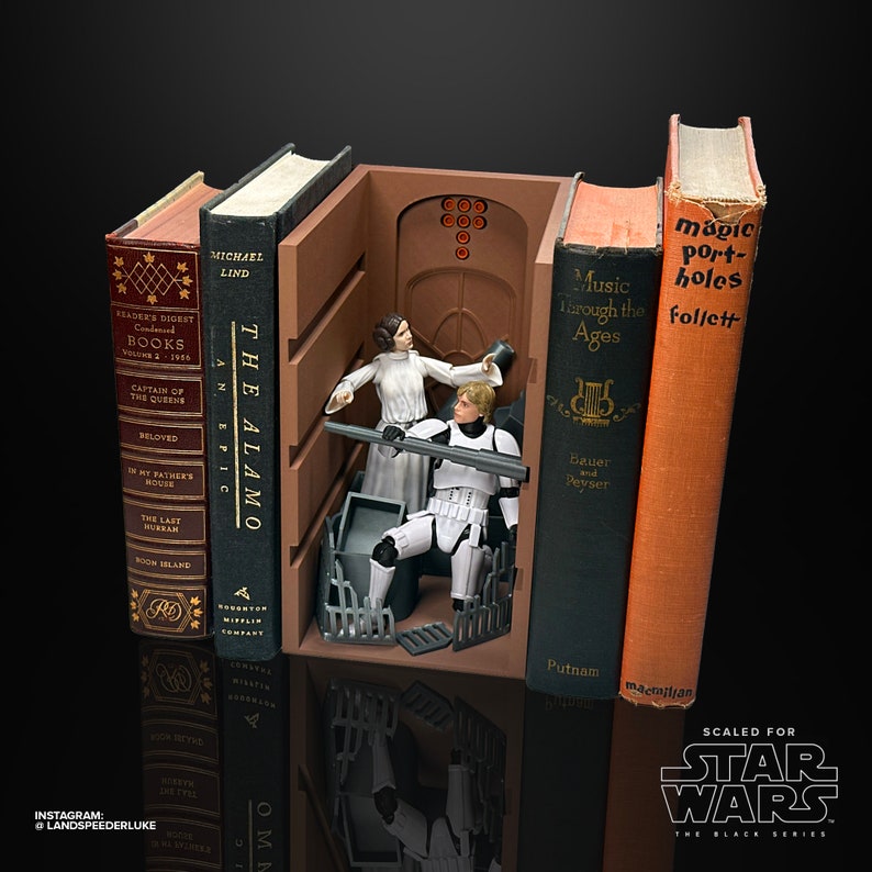 May include: A Star Wars themed bookend set featuring Princess Leia and Han Solo figures from the Black Series. The bookends are designed to look like a scene from the movie, with a doorway and a fence. The bookends are made of plastic and are approximately 6 inches tall.