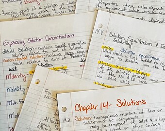 May include: A collection of handwritten notes on lined paper, with various chemistry concepts and equations. Topics include freezing point depression, solution concentrations, and colligative properties. The notes are highlighted with yellow markers.