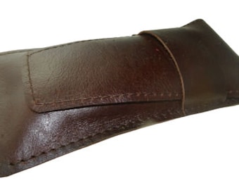 May include: A brown leather case for glasses or other small items. The case has a flap that closes with a snap.